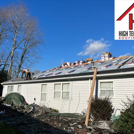 Roof replacement in progress on a residential house under clear blue skies. High Tech Roofing logo.